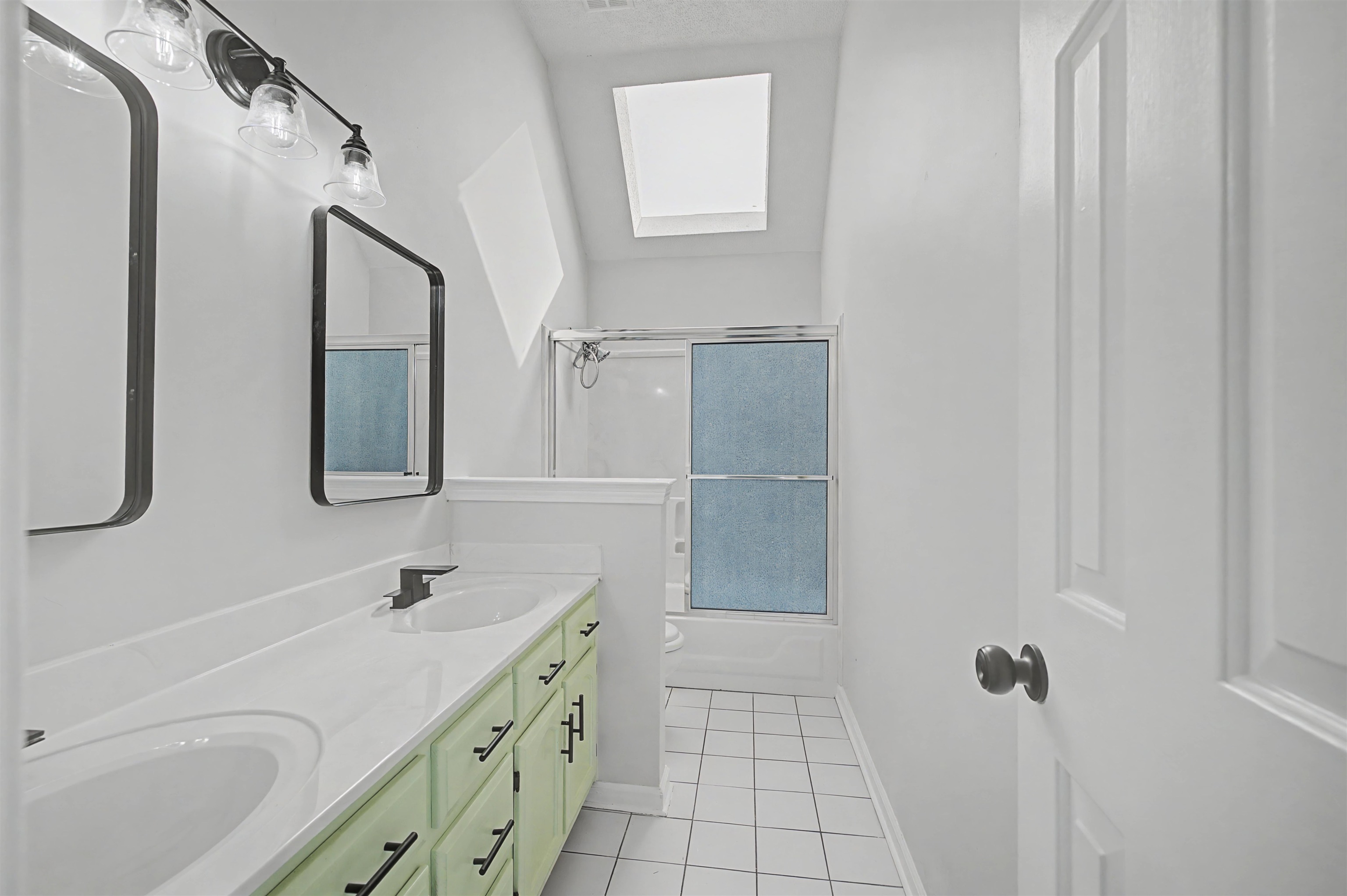 8208 Clinton Way Cove Memphis, TN 38018 - Photo 11 of 31 a bathroom with a double vanity sink a mirror and a shower