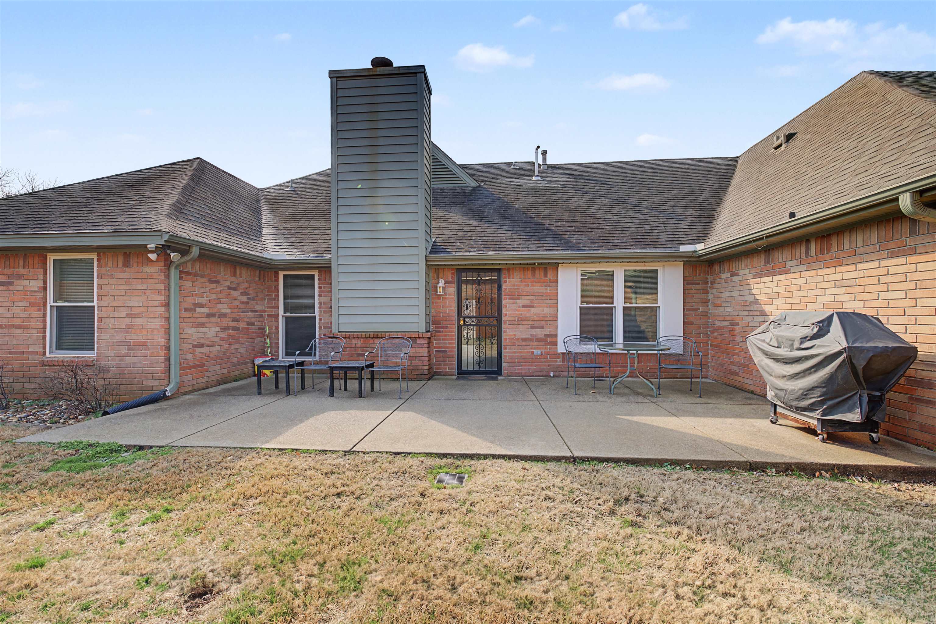 8208 Clinton Way Cove Memphis, TN 38018 - Photo 28 of 31 a backyard of a house with barbeque oven table and chairs