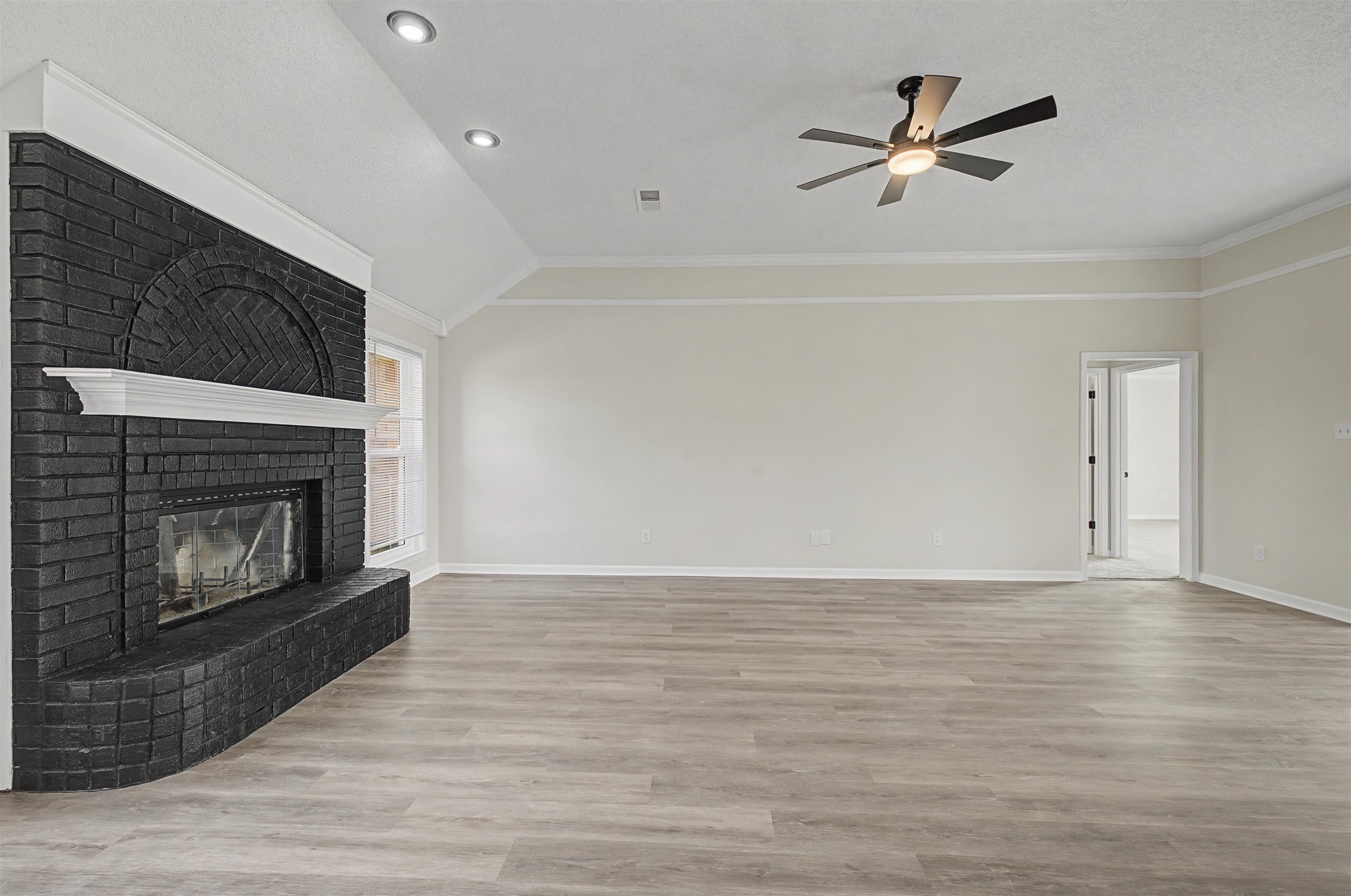 8208 Clinton Way Cove Memphis, TN 38018 - Photo 9 of 31 a view of wooden floor a fireplace and a chandelier in a room