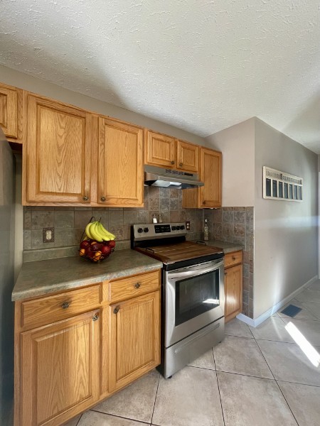 460 Mate Allen Road Gainesboro, TN 38562 - Photo 19 of 49 a kitchen with granite countertop a stove sink and cabinets