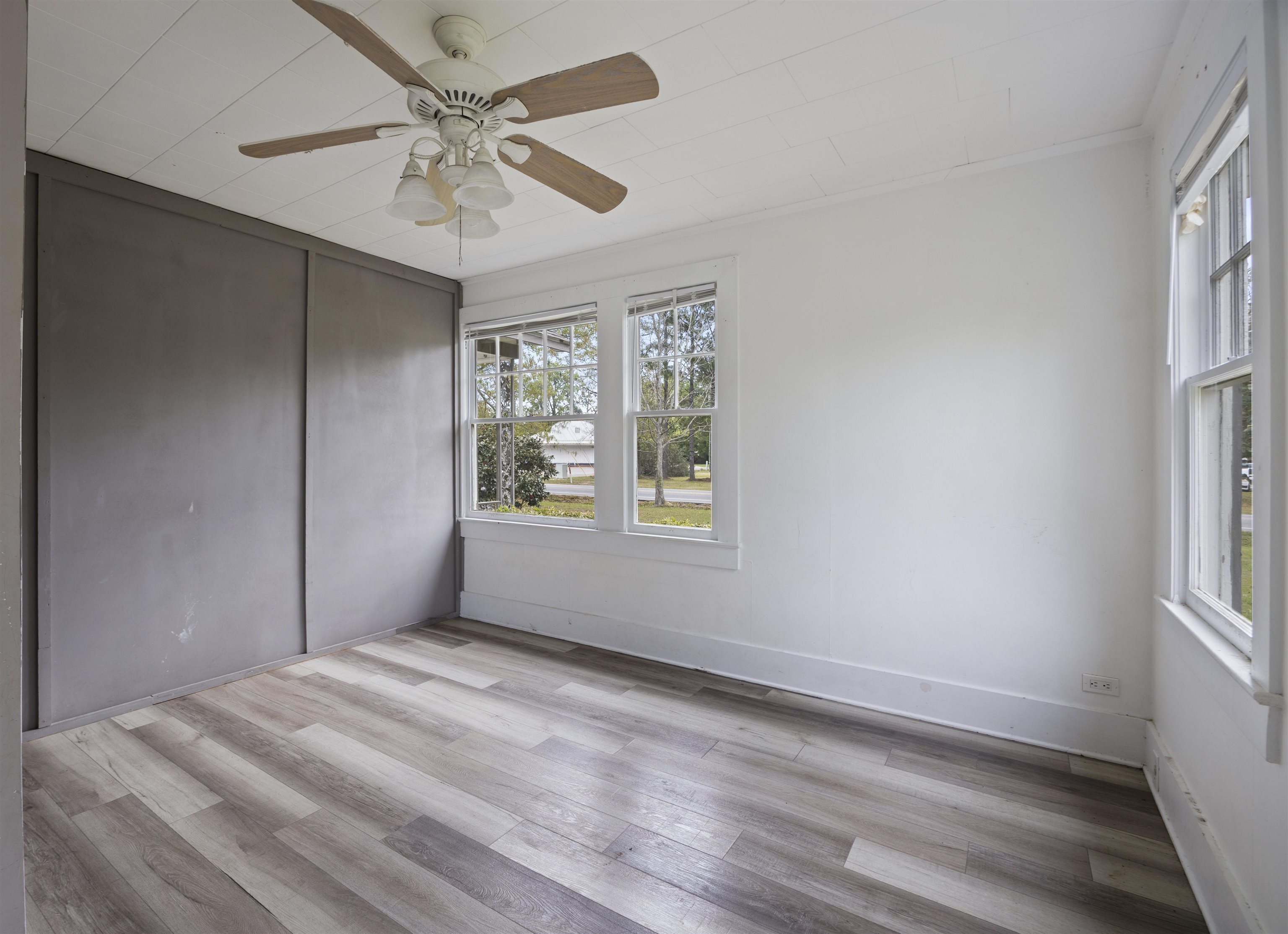 112 South Juniper Street Foley, AL 36535 - Photo 34 of 64 Unfurnished bedroom featuring light wood-style flooring, a ceiling fan, and a closet
