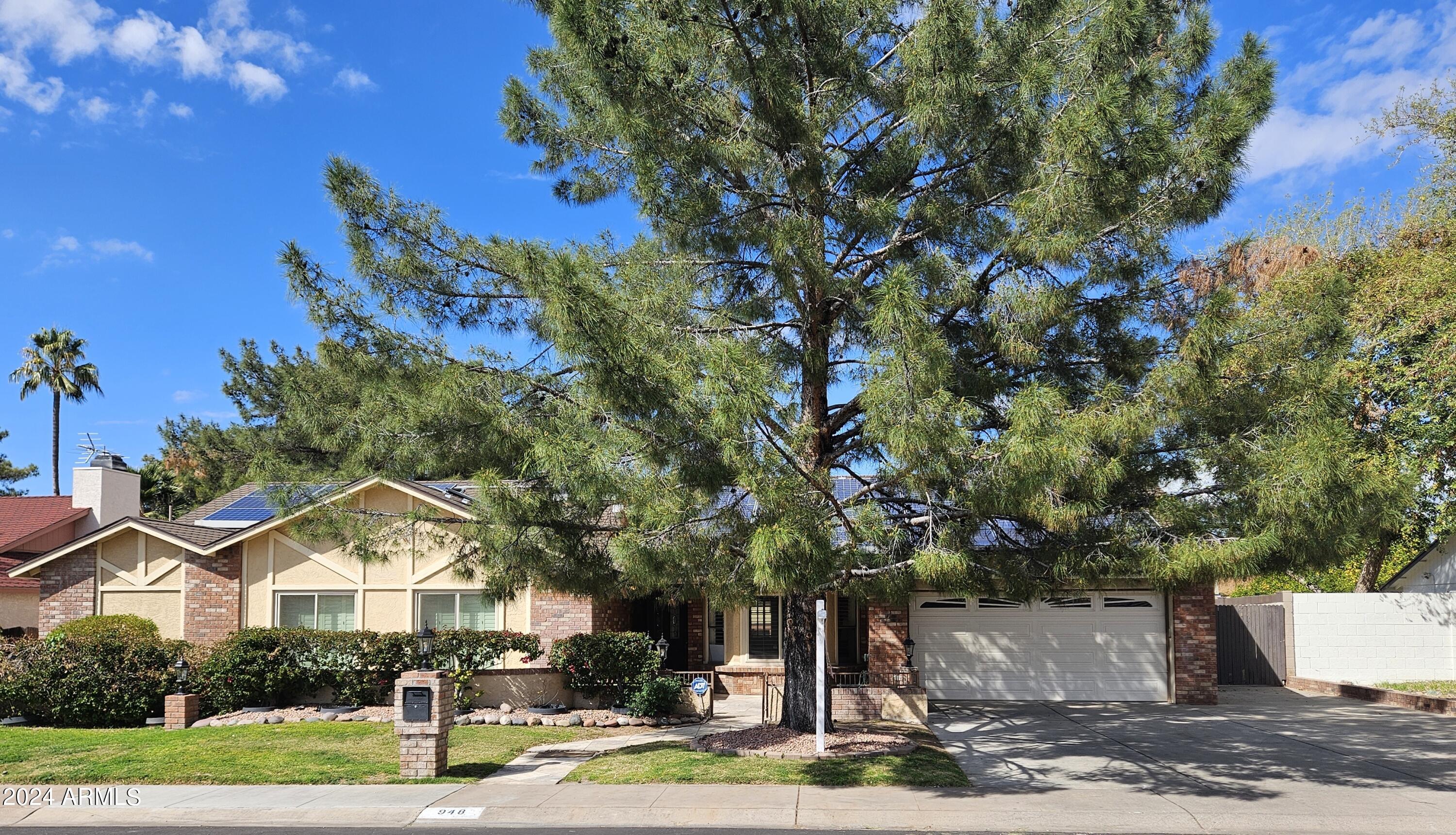 948 East Grandview Road Phoenix, AZ 85022 - Photo 1 of 43 a front view of a house with a yard and tree s