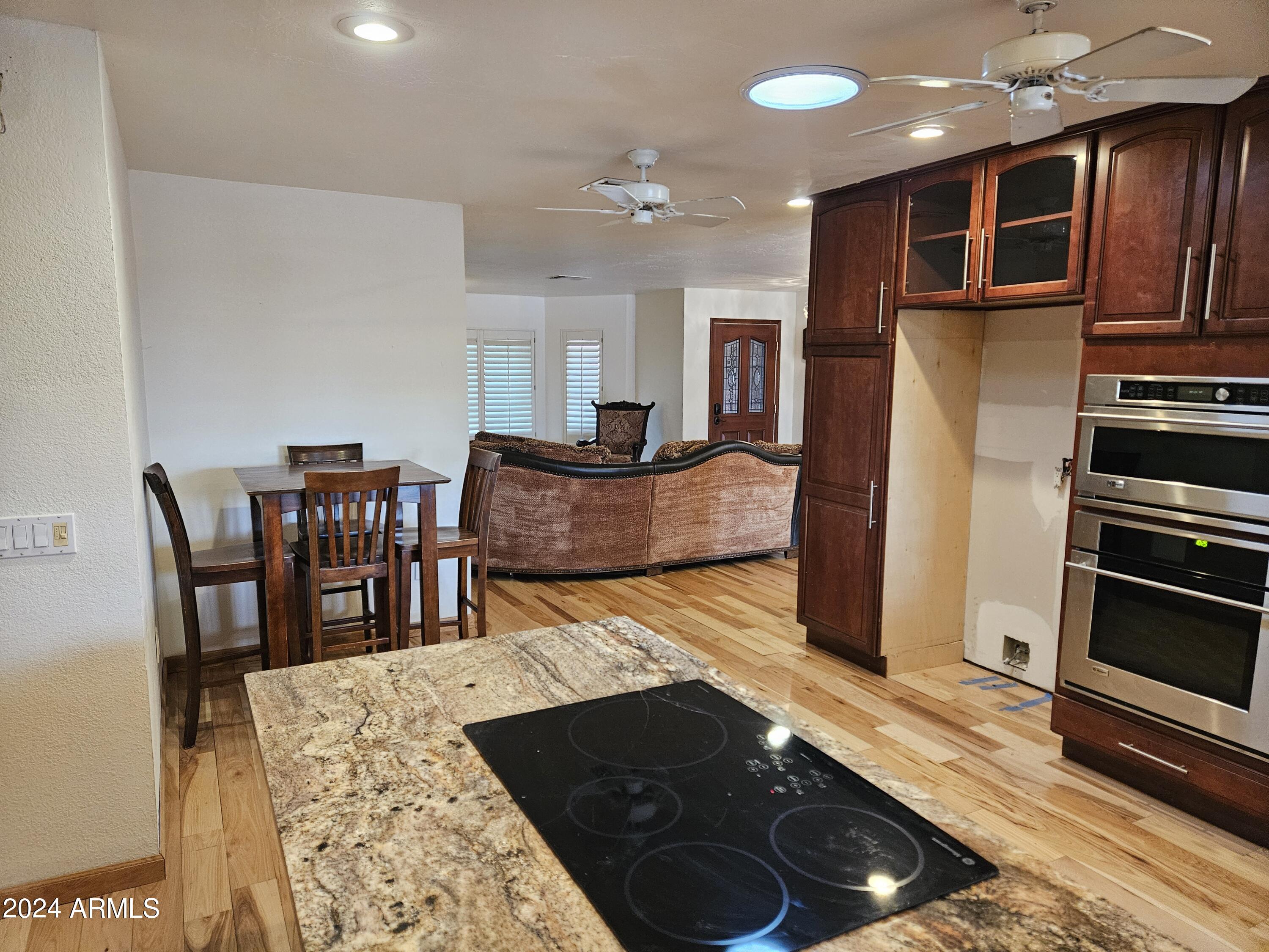 948 East Grandview Road Phoenix, AZ 85022 - Photo 11 of 43 a kitchen with stainless steel appliances granite countertop a stove refrigerator and cabinets