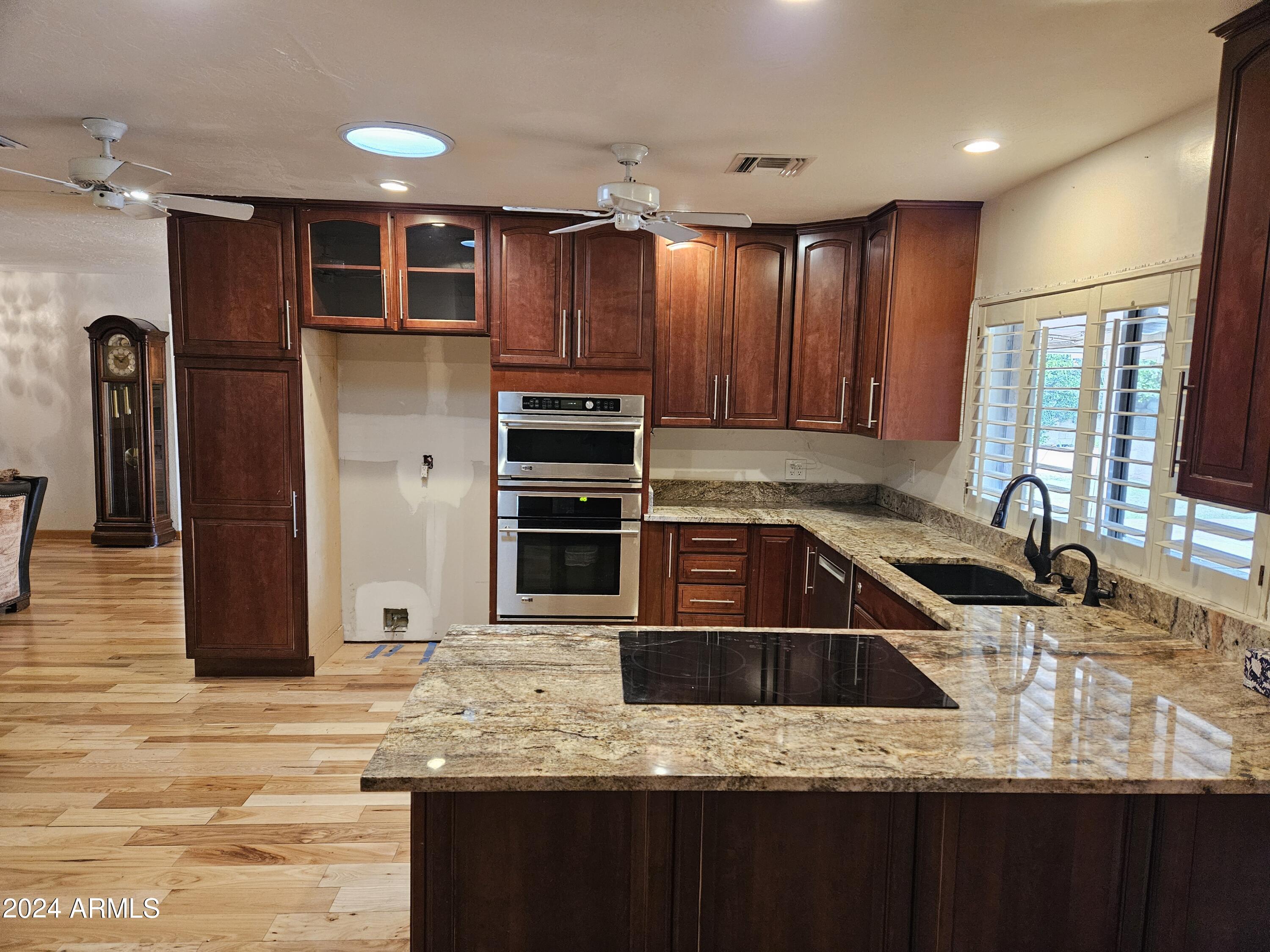948 East Grandview Road Phoenix, AZ 85022 - Photo 12 of 43 a kitchen with stainless steel appliances granite countertop a sink stove and refrigerator