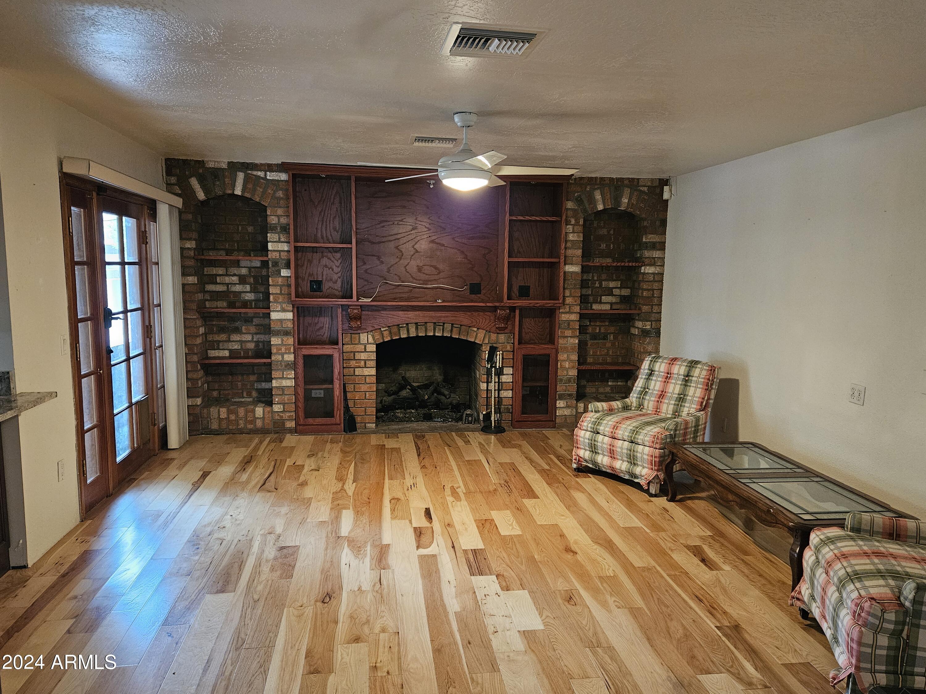 948 East Grandview Road Phoenix, AZ 85022 - Photo 14 of 43 a living room with furniture a fireplace and a book shelf