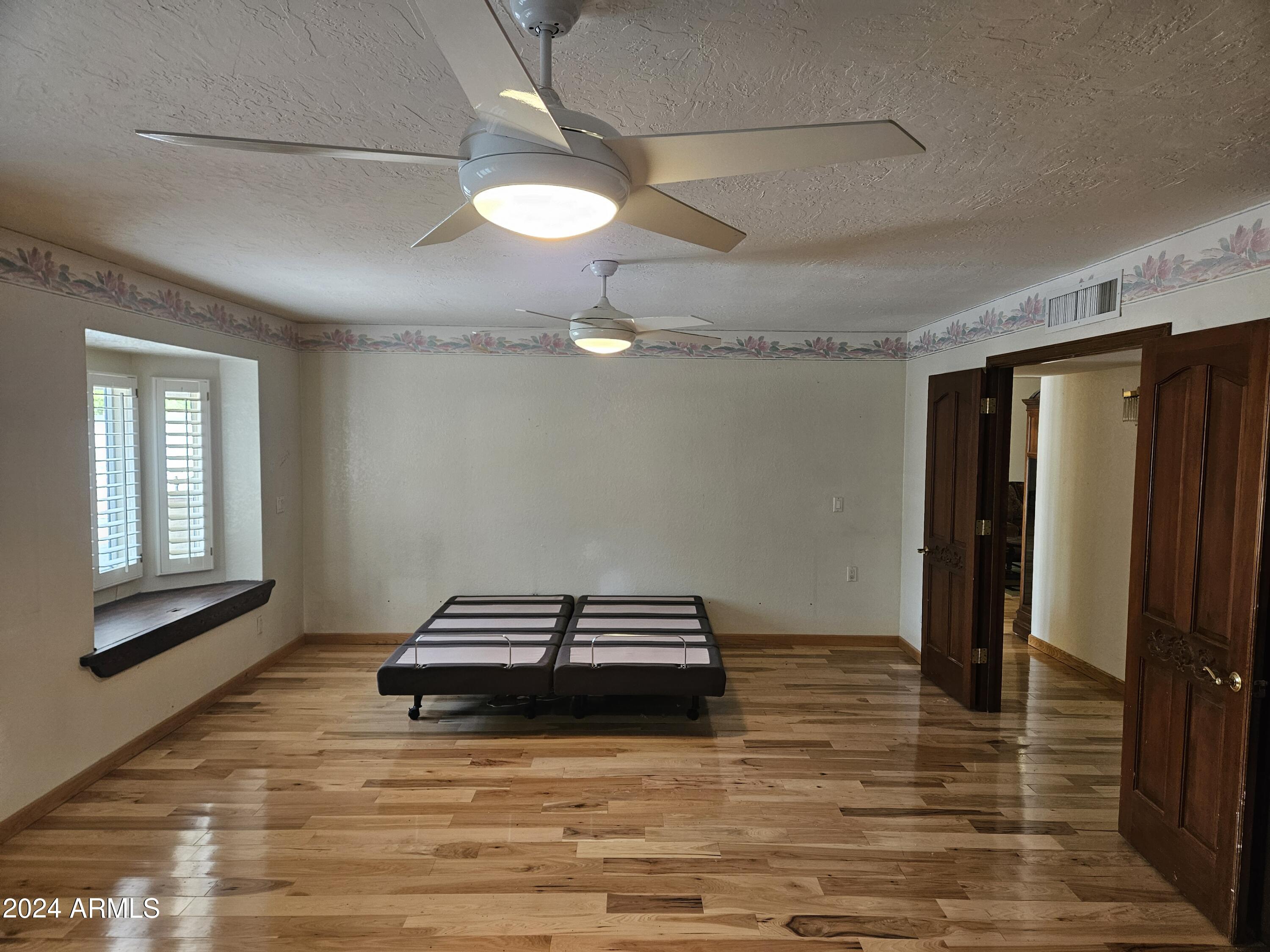 948 East Grandview Road Phoenix, AZ 85022 - Photo 17 of 43 a view of a livingroom with wooden floor and a ceiling fan
