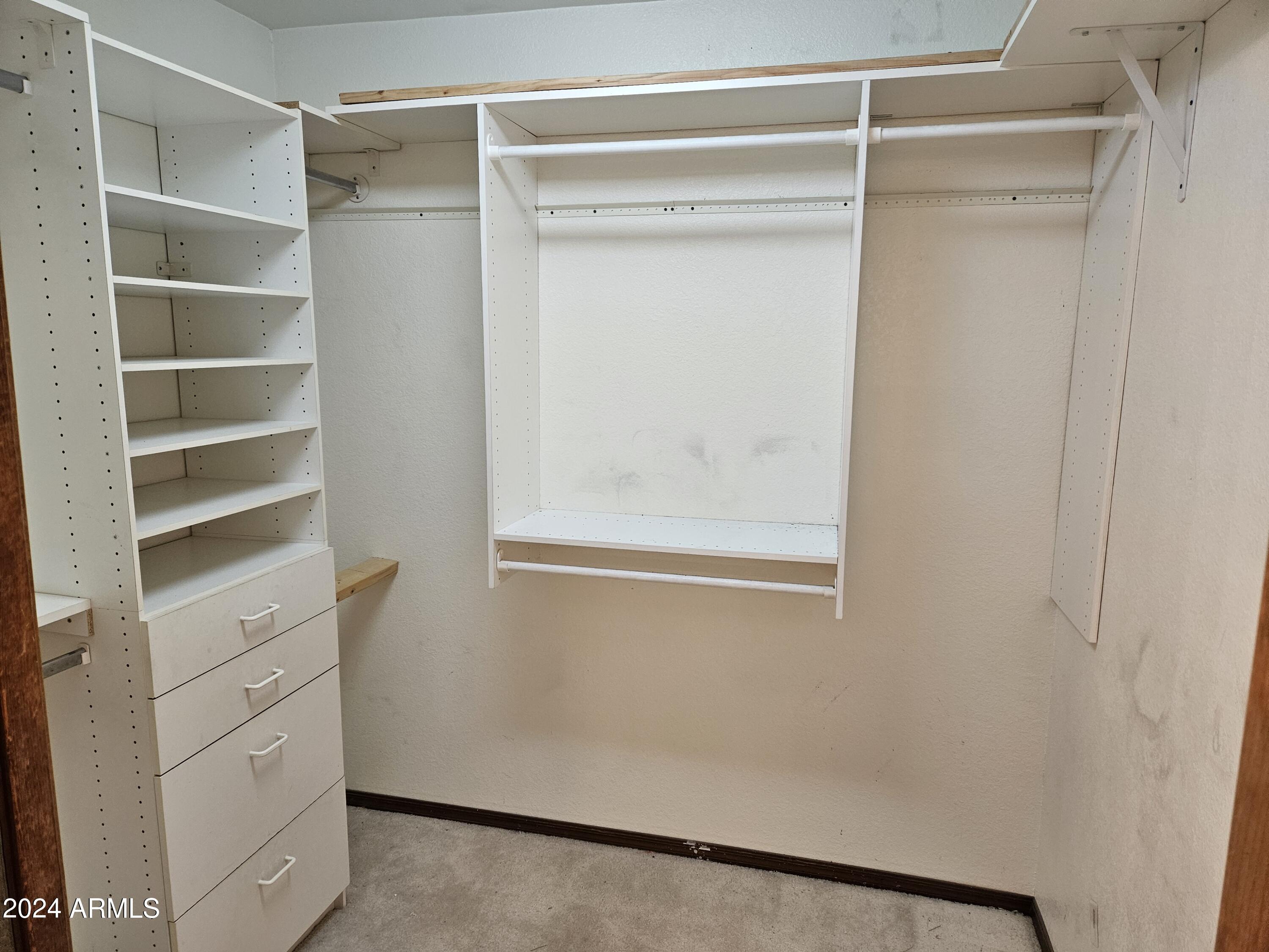 948 East Grandview Road Phoenix, AZ 85022 - Photo 23 of 43 a view of walk in closet with empty racks