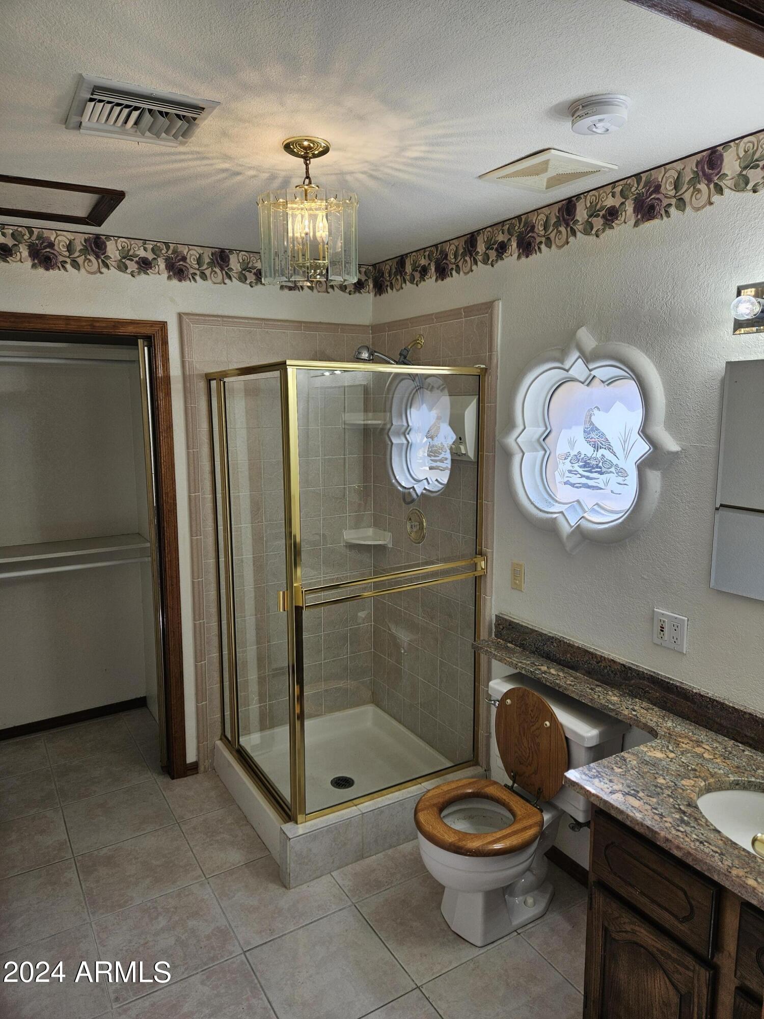948 East Grandview Road Phoenix, AZ 85022 - Photo 27 of 43 a bathroom with a granite countertop sink a toilet and a mirror