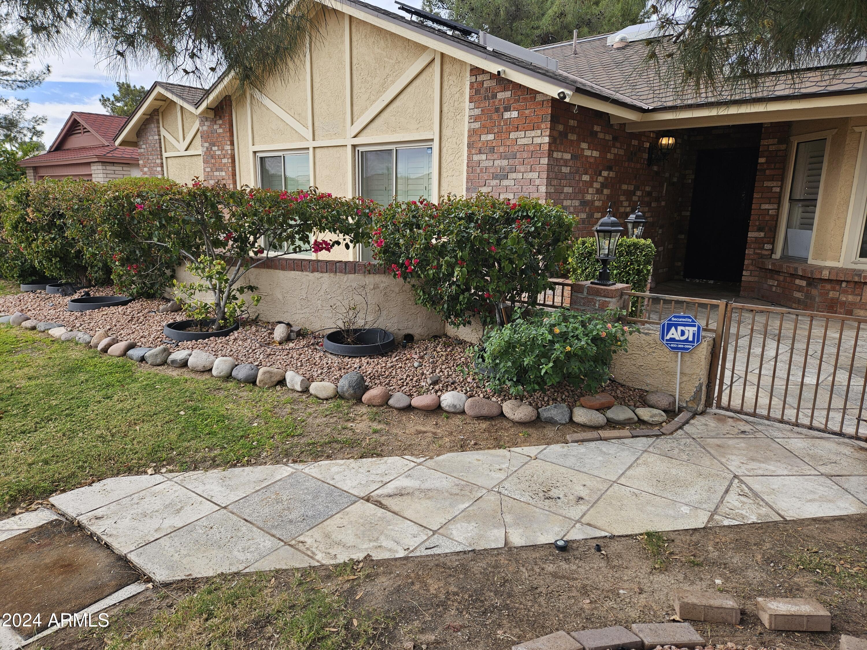 948 East Grandview Road Phoenix, AZ 85022 - Photo 3 of 43 a front view of a house with garden