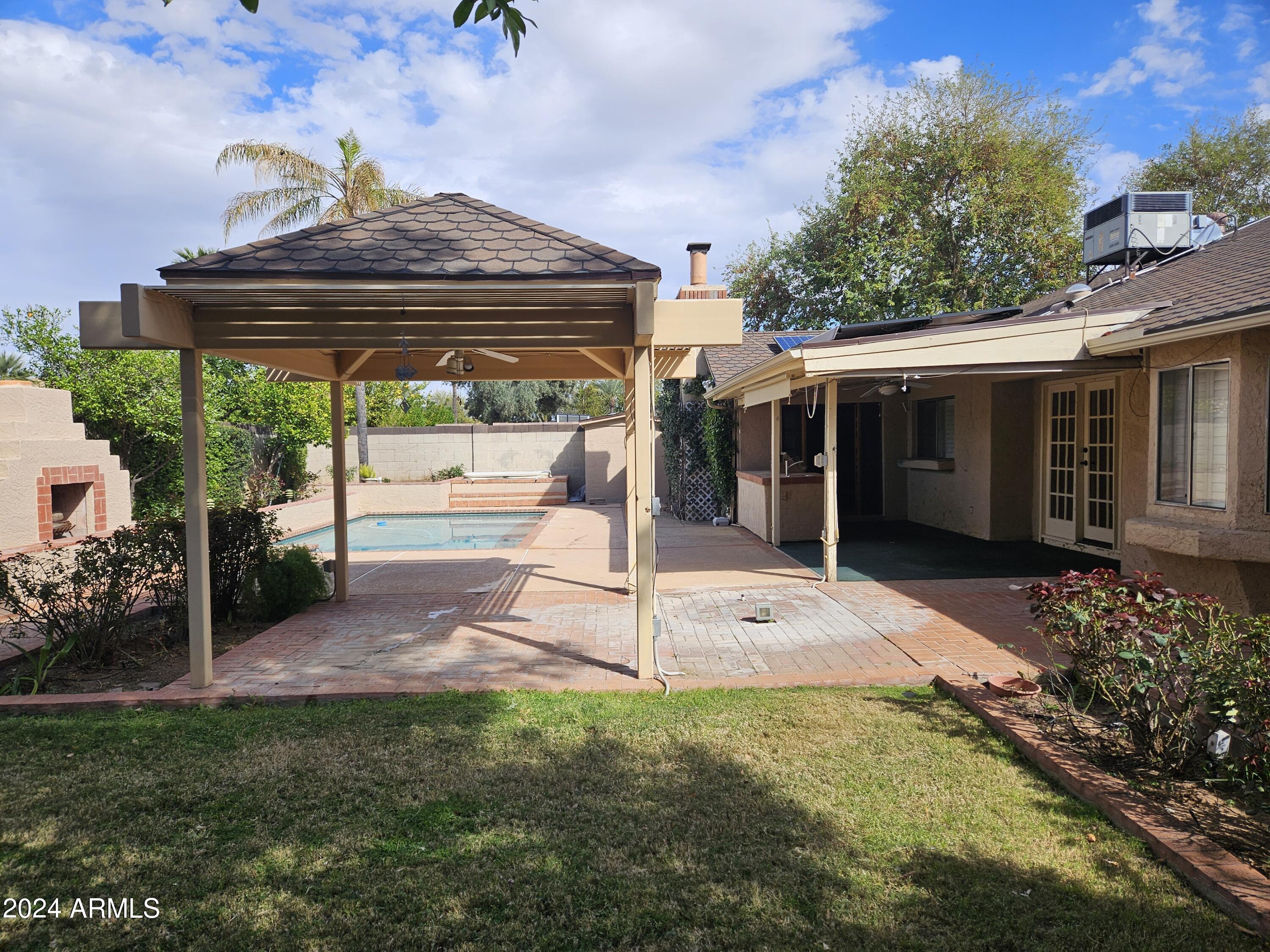 948 East Grandview Road Phoenix, AZ 85022 - Photo 35 of 43 a view of a porch with a table and chairs under an umbrella