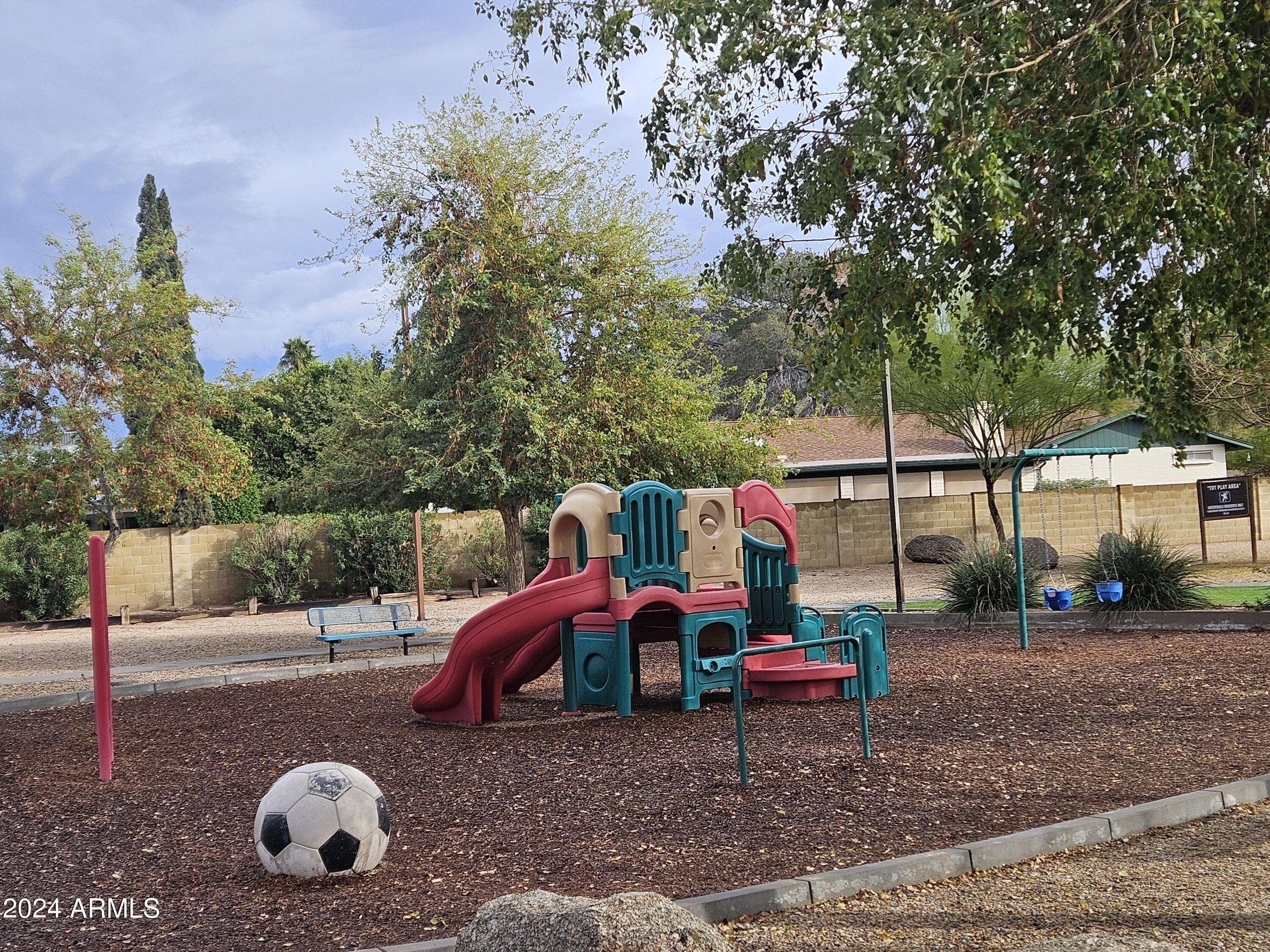948 East Grandview Road Phoenix, AZ 85022 - Photo 39 of 43 a childrens park with lots of swings slides and swimming pool in the back