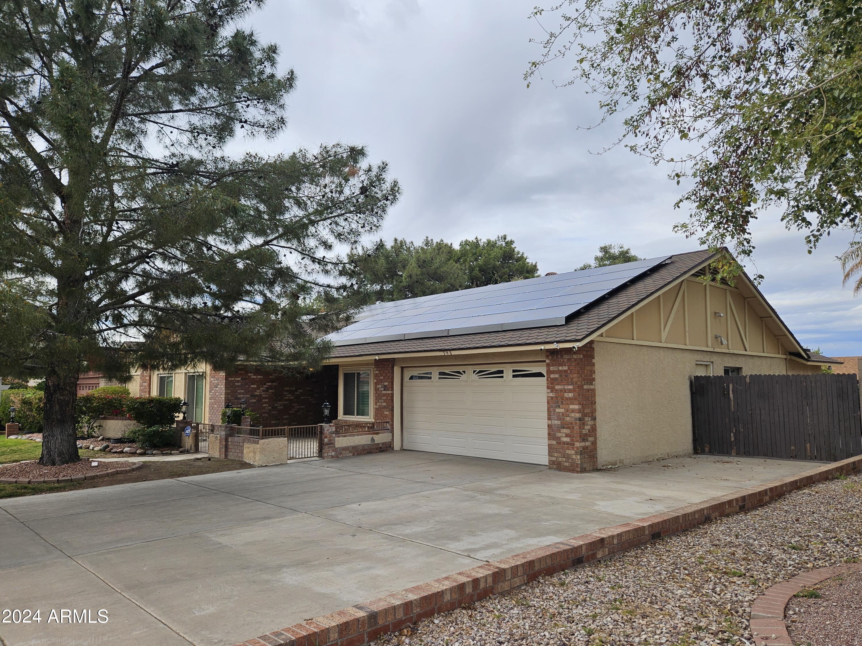 948 East Grandview Road Phoenix, AZ 85022 - Photo 4 of 43 a view of a white house with a large tree
