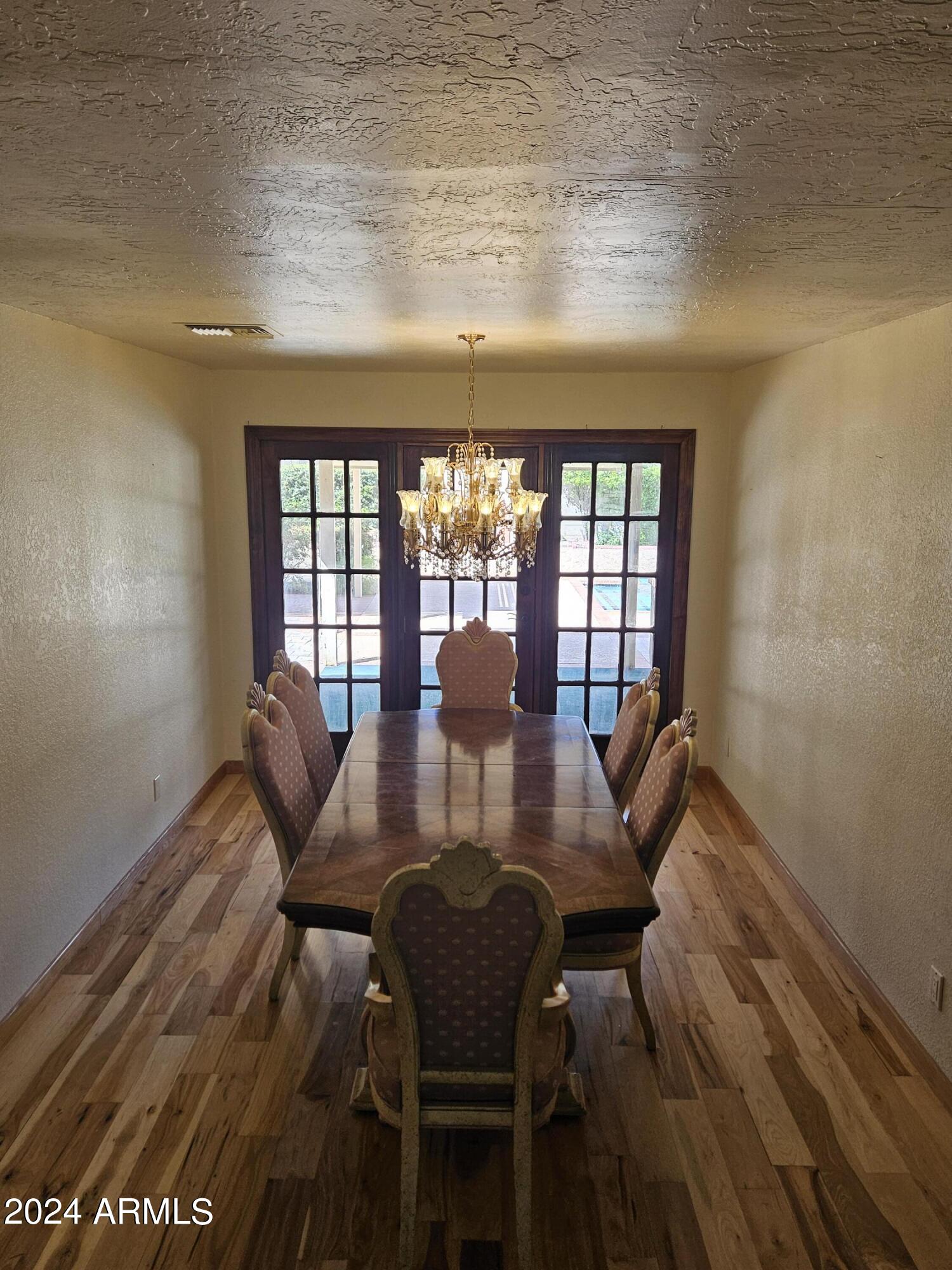 948 East Grandview Road Phoenix, AZ 85022 - Photo 10 of 43 a view of a dining room with furniture a chandelier and wooden floor