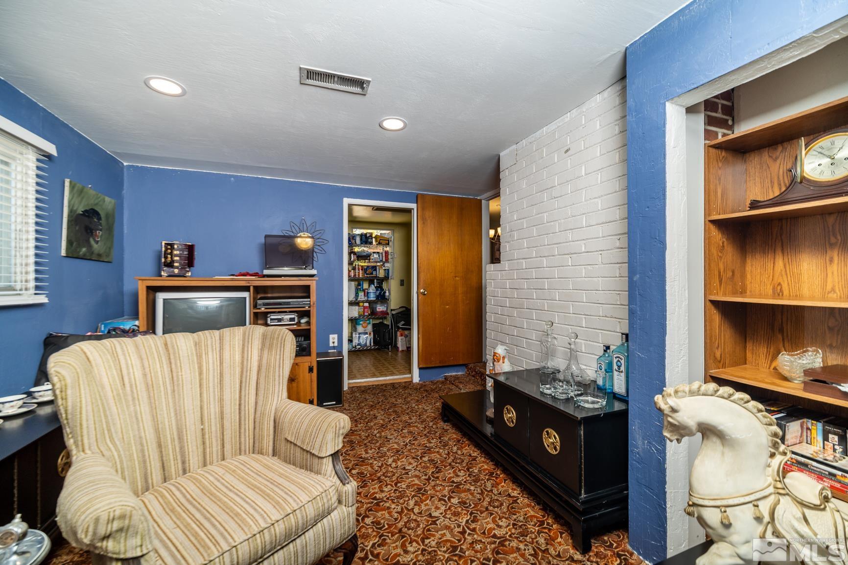 780 Stoker Avenue Reno, NV 89503 - Photo 12 of 25 a living room with furniture a rug and a fireplace