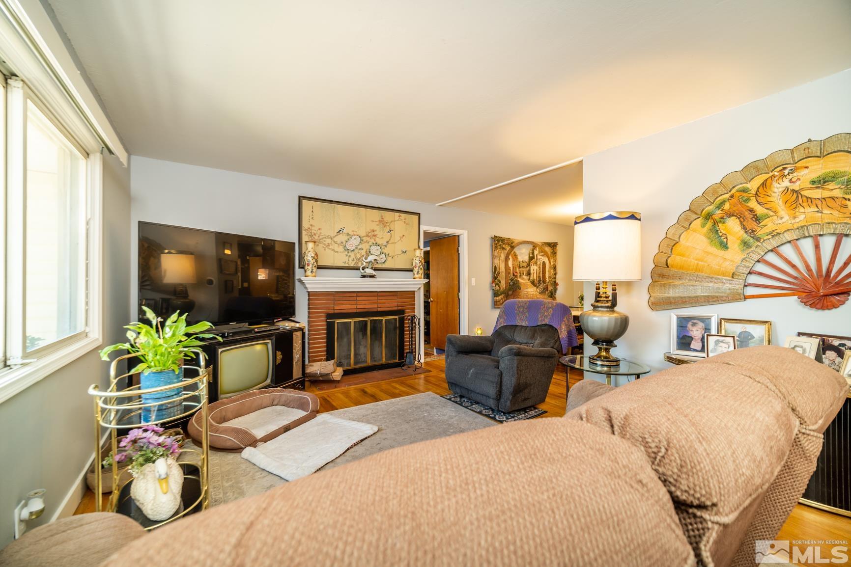 780 Stoker Avenue Reno, NV 89503 - Photo 3 of 25 a living room with furniture a flat screen tv and a fireplace