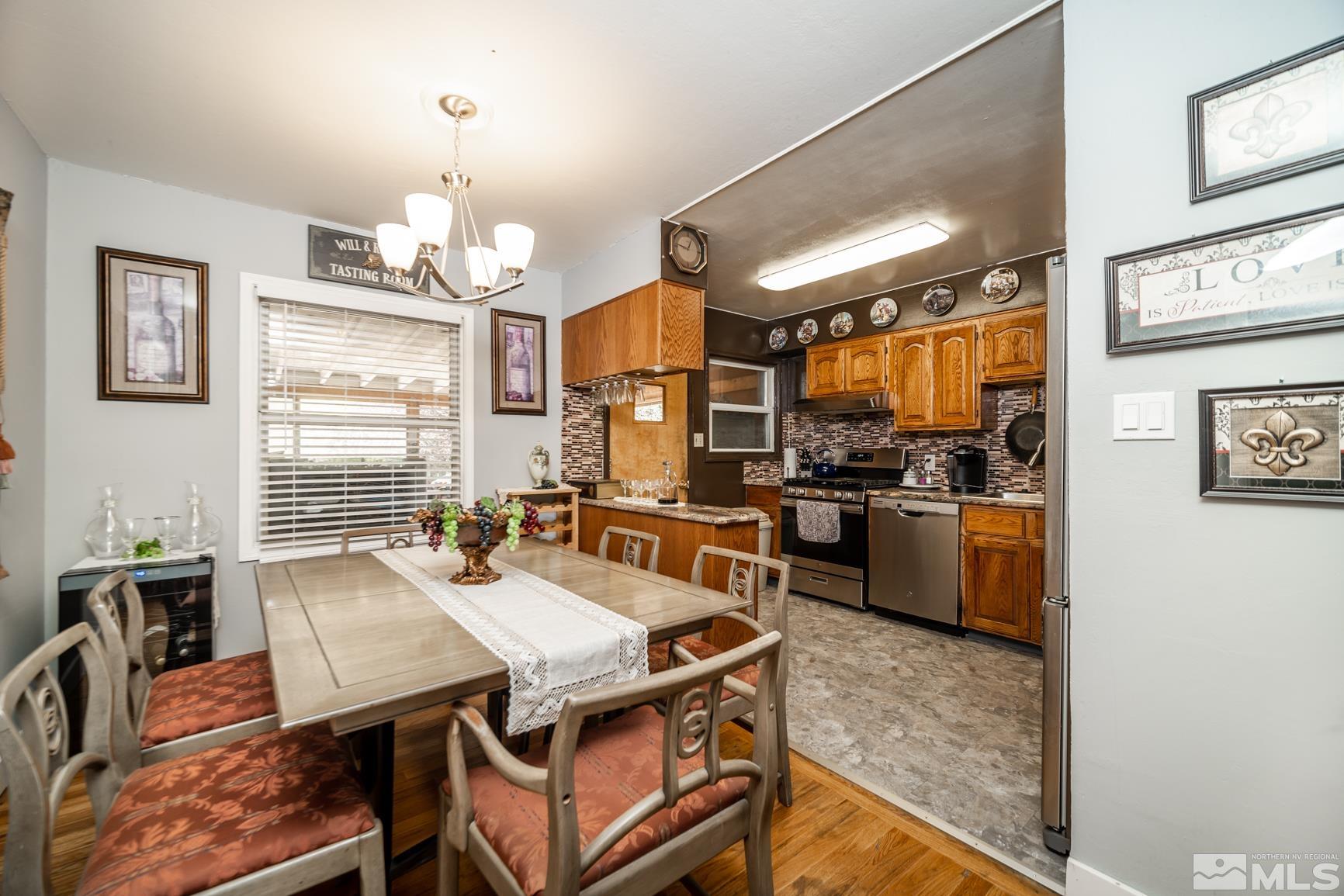 780 Stoker Avenue Reno, NV 89503 - Photo 6 of 25 a view of a dining room with furniture a kitchen and chandelier