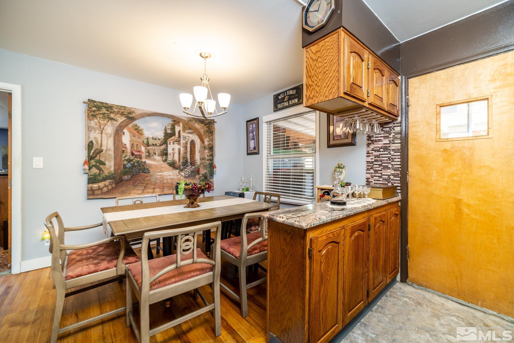 780 Stoker Avenue Reno, NV 89503 - Photo 9 of 25 a kitchen with stainless steel appliances granite countertop a stove a sink dishwasher and cabinets with wooden floor