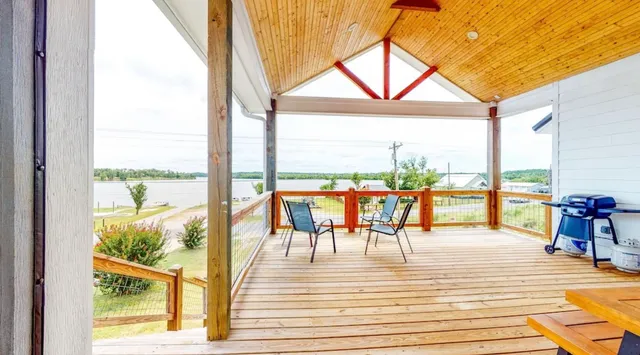 a view of a balcony with wooden floor and outdoor space