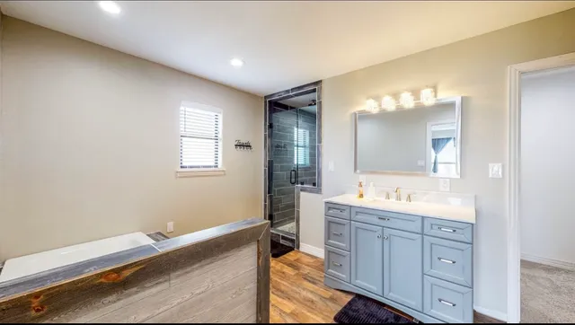 a spacious bathroom with a granite countertop sink mirror and a