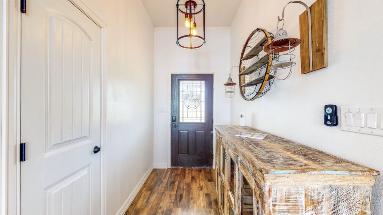 850 Triple Creek Loop Livingston, TX 77351 - Photo 16 of 18 a bedroom with a bed and a chandelier