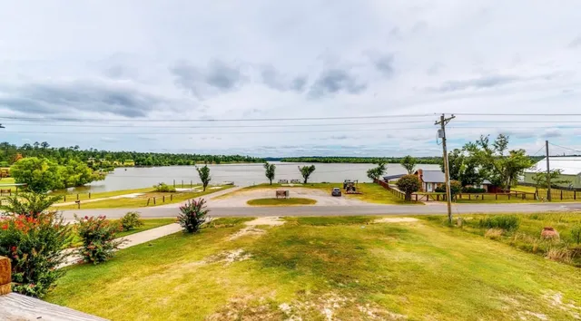 a view of a swimming pool with an outdoor seating and a many windows