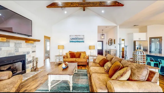 a living room with furniture fireplace and a flat screen tv