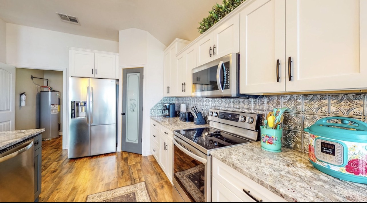850 Triple Creek Loop Livingston, TX 77351 - Photo 8 of 18 a kitchen with stainless steel appliances granite countertop a stove a sink and a refrigerator