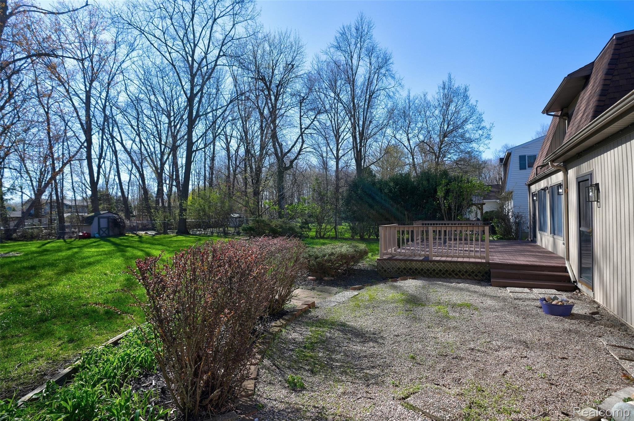 6273 Cold Spring Trail Grand Blanc, MI 48439 - Photo 7 of 48 View of yard with a wooden deck and a storage shed