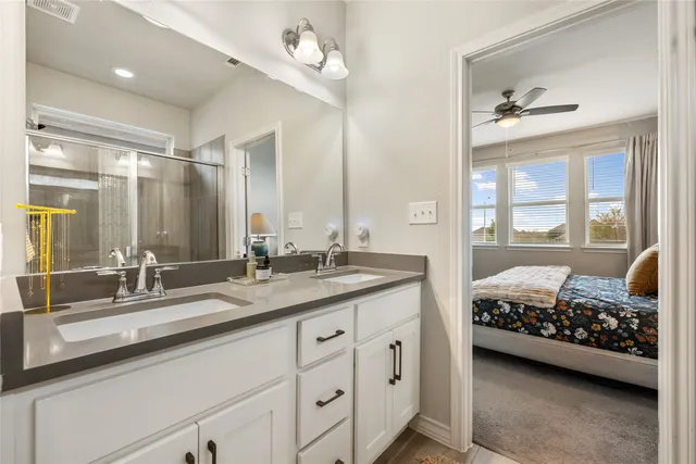 a bathroom with a glass shower door and a bathtub