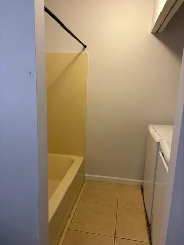 a bathroom with a tub and shower