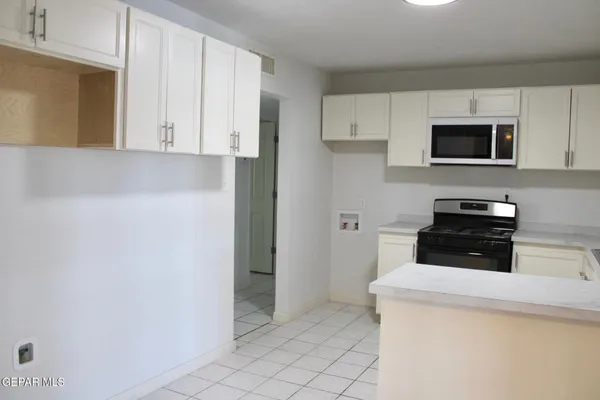a kitchen with a cabinets and appliances