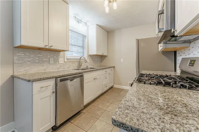 a kitchen with a sink stove and cabinets