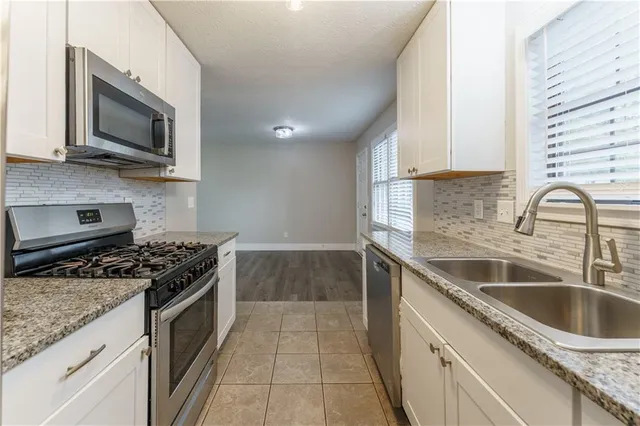 a kitchen that has a sink and a stove