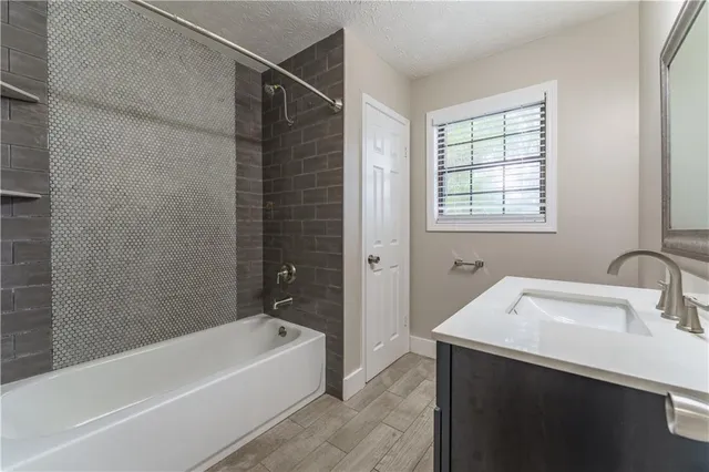 a bathroom with a bathtub and a sink