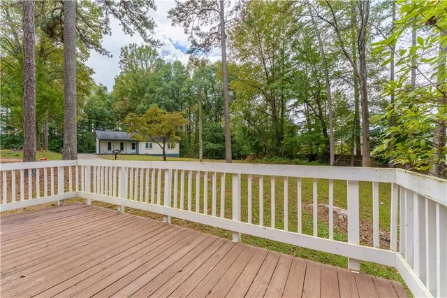 a balcony with wooden floor and fence
