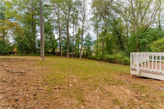 a view of a yard with wooden fence