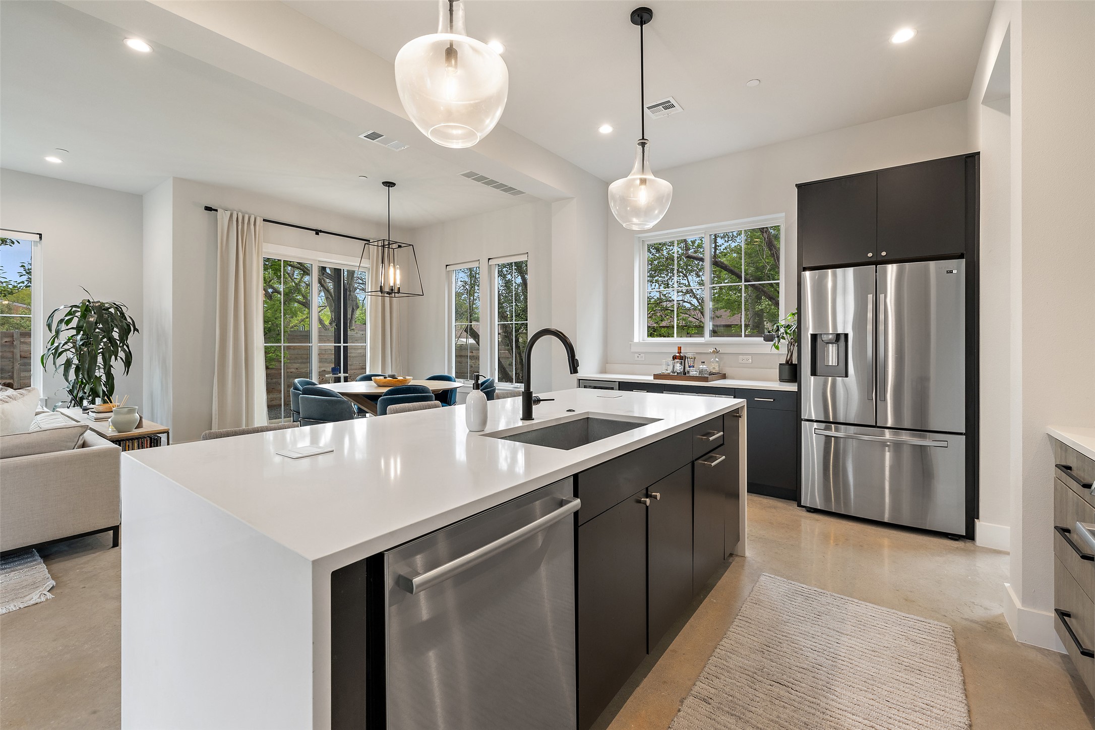 1504 Ruth Avenue, Unit 3 Austin, TX 78757 - Photo 13 of 39 An open concept kitchen features sleek cabinetry, a substantial island, and premium stainless steel appliances.