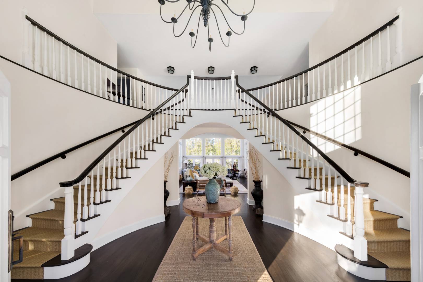 495 Ox Pasture Road Southampton, NY 11968 - Photo 2 of 28 a view of staircase with lots of frames on wall and wooden floor