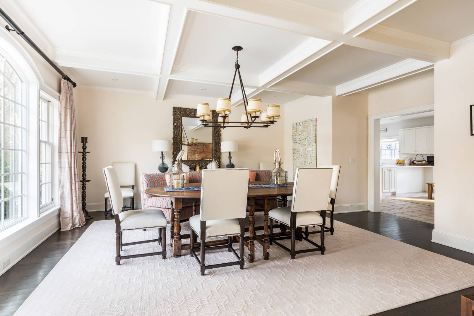 495 Ox Pasture Road Southampton, NY 11968 - Photo 5 of 28 a dining room with wooden floor a chandelier a wooden table and chairs