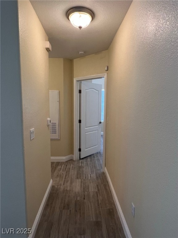 8805 Jeffreys Street, Unit 1111 Las Vegas, NV 89123 - Photo 20 of 35 Hall with dark wood-type flooring, a textured ceiling, and a textured wall