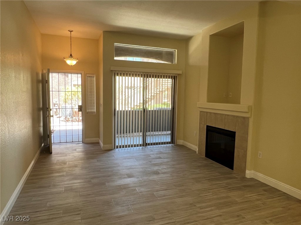 8805 Jeffreys Street, Unit 1111 Las Vegas, NV 89123 - Photo 2 of 35 Unfurnished living room featuring a fireplace and wood finished floors