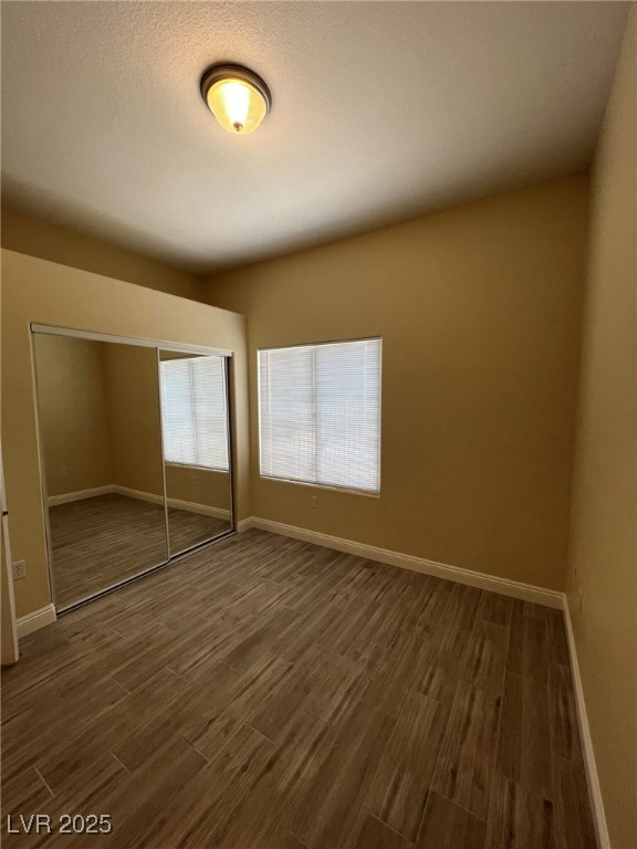 8805 Jeffreys Street, Unit 1111 Las Vegas, NV 89123 - Photo 21 of 35 Unfurnished bedroom featuring dark wood-type flooring and a closet