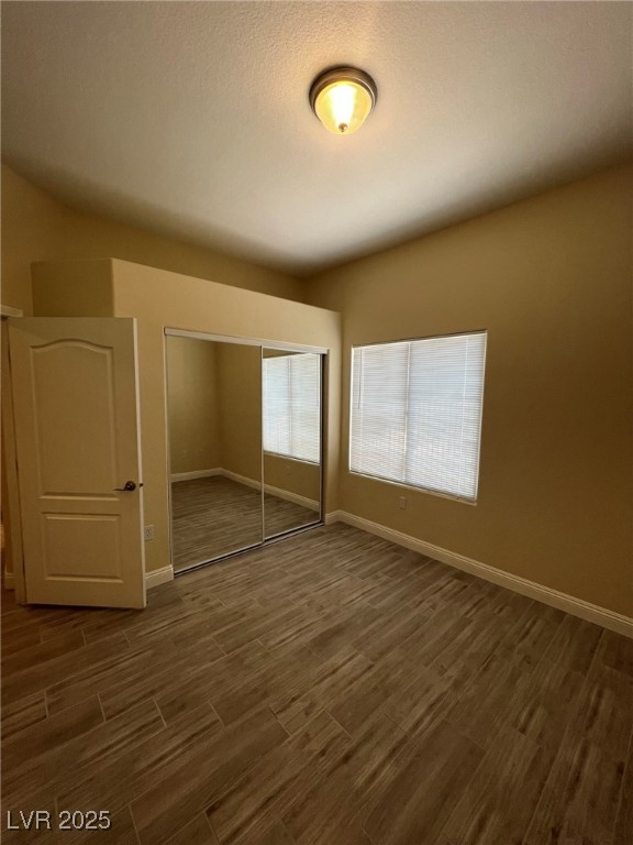 8805 Jeffreys Street, Unit 1111 Las Vegas, NV 89123 - Photo 22 of 35 Unfurnished bedroom with dark wood finished floors and a closet