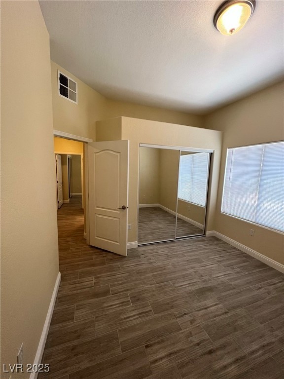 8805 Jeffreys Street, Unit 1111 Las Vegas, NV 89123 - Photo 23 of 35 Unfurnished bedroom featuring a closet and dark wood-style floors