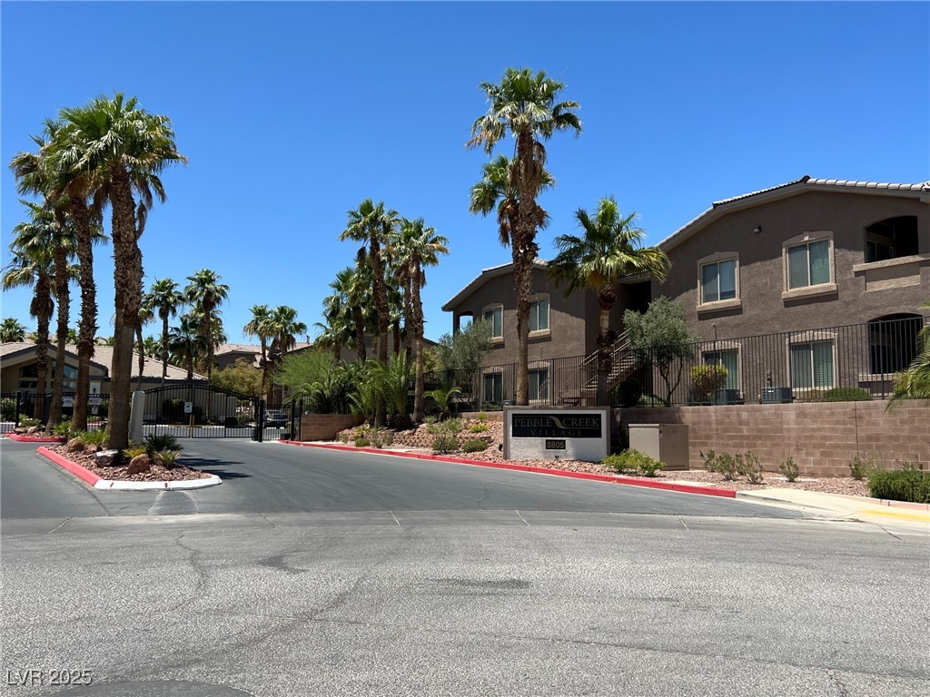 8805 Jeffreys Street, Unit 1111 Las Vegas, NV 89123 - Photo 35 of 35 View of asphalt street featuring curbs and a gated entry