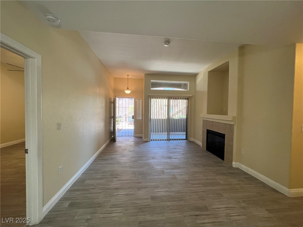 8805 Jeffreys Street, Unit 1111 Las Vegas, NV 89123 - Photo 6 of 35 Unfurnished living room with wood finished floors and a tile fireplace