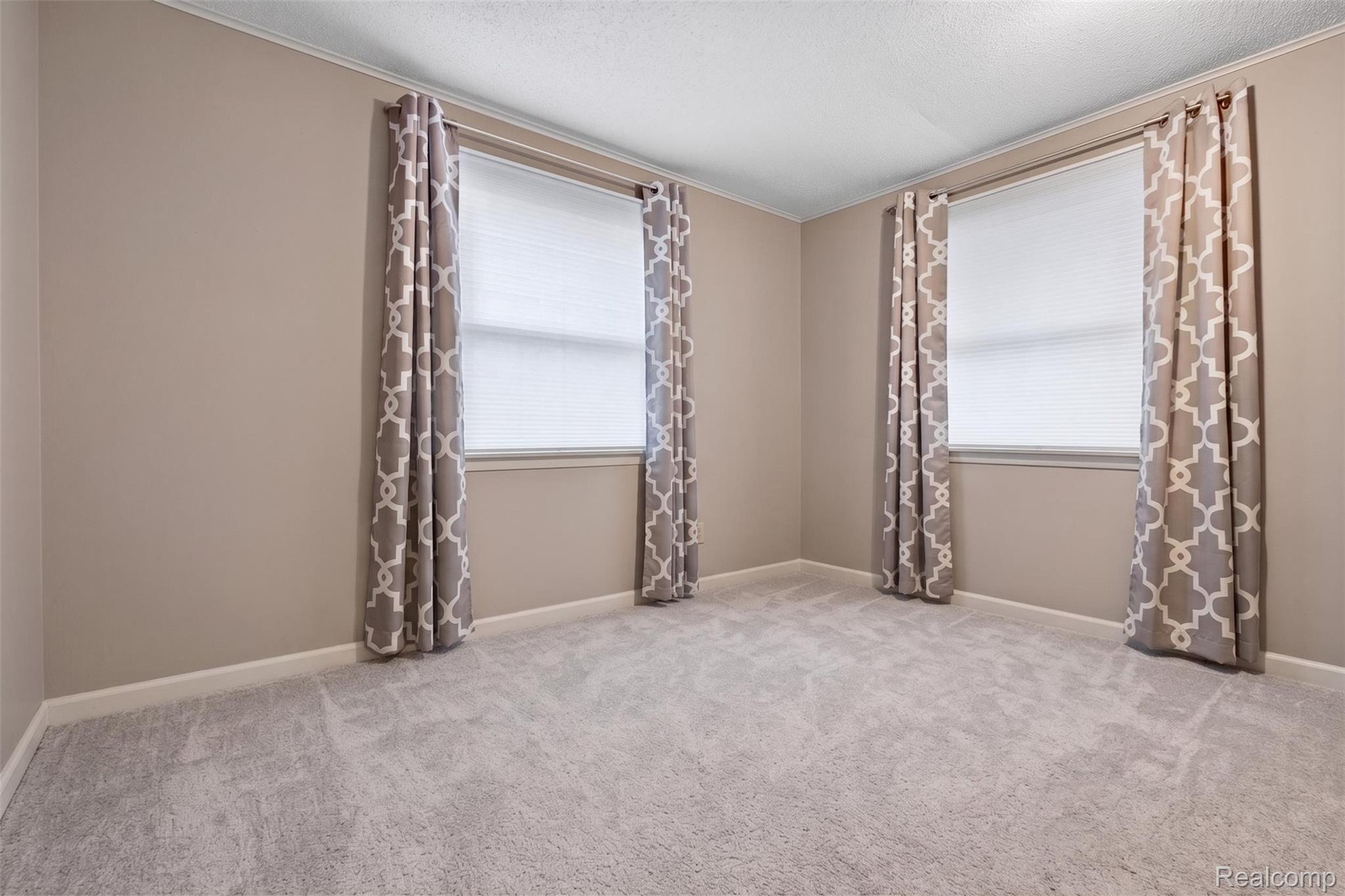 5977 Anglers Road Ortonville, MI 48462 - Photo 22 of 63 Neutral-toned walls complement light gray carpeting