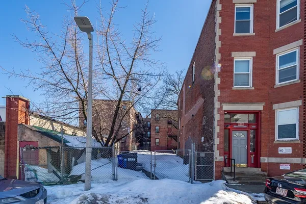 a backyard of a building with multiple trees