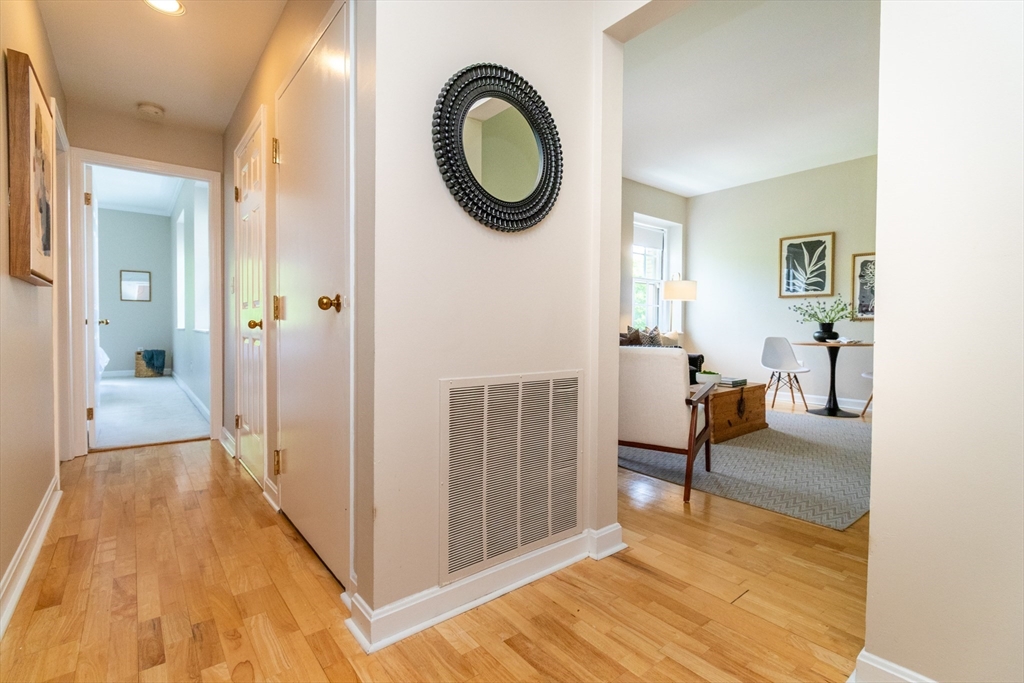 60e Glen Road, Unit 306 Brookline, MA 02445 - Photo 5 of 27 a view of a livingroom with furniture and front door