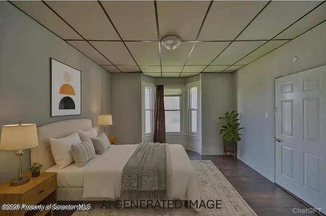 a bedroom with a large bed and a potted plant